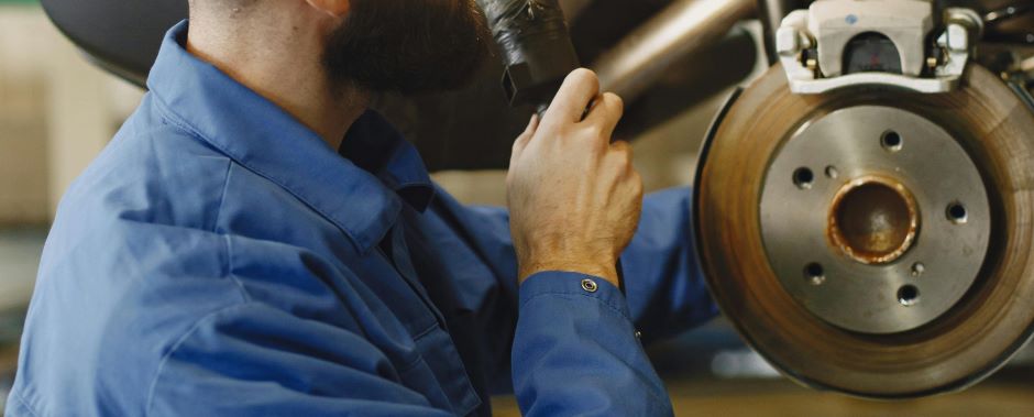 person working on a car brakes